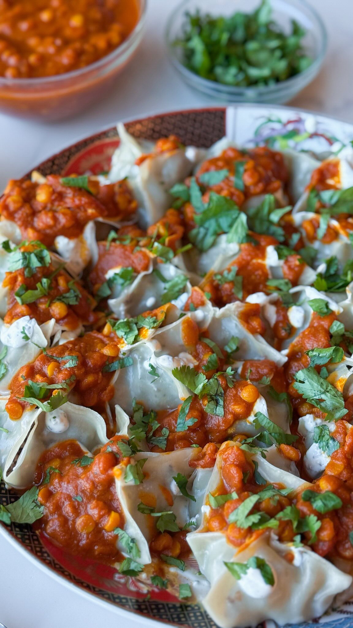 Afghan Mantu (beef dumplings with onion-herb filling) with roasted garlic tomato sauce