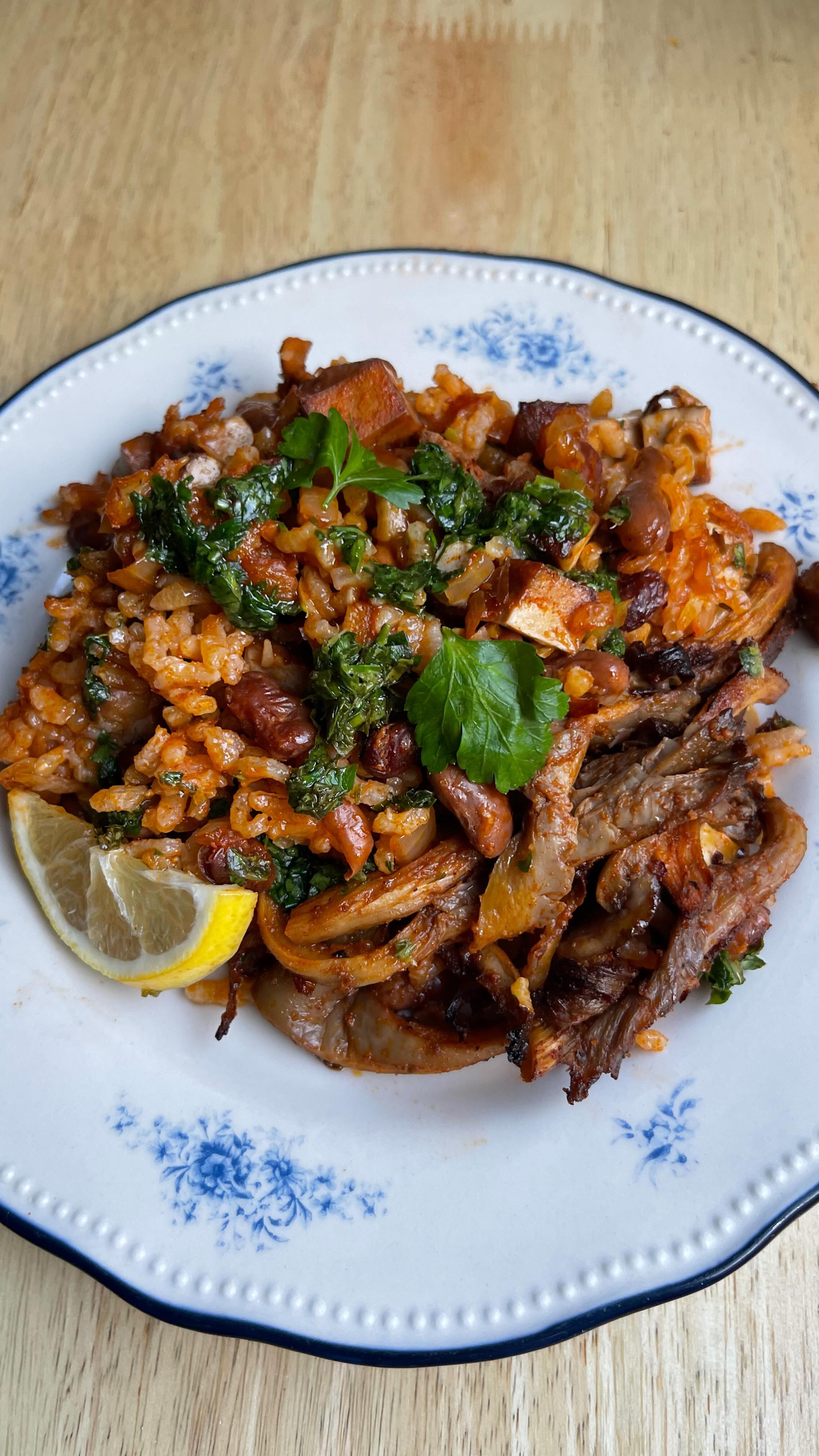 Smoky Portuguese baked rice with piri piri mushrooms and green herb sauce (vegan)