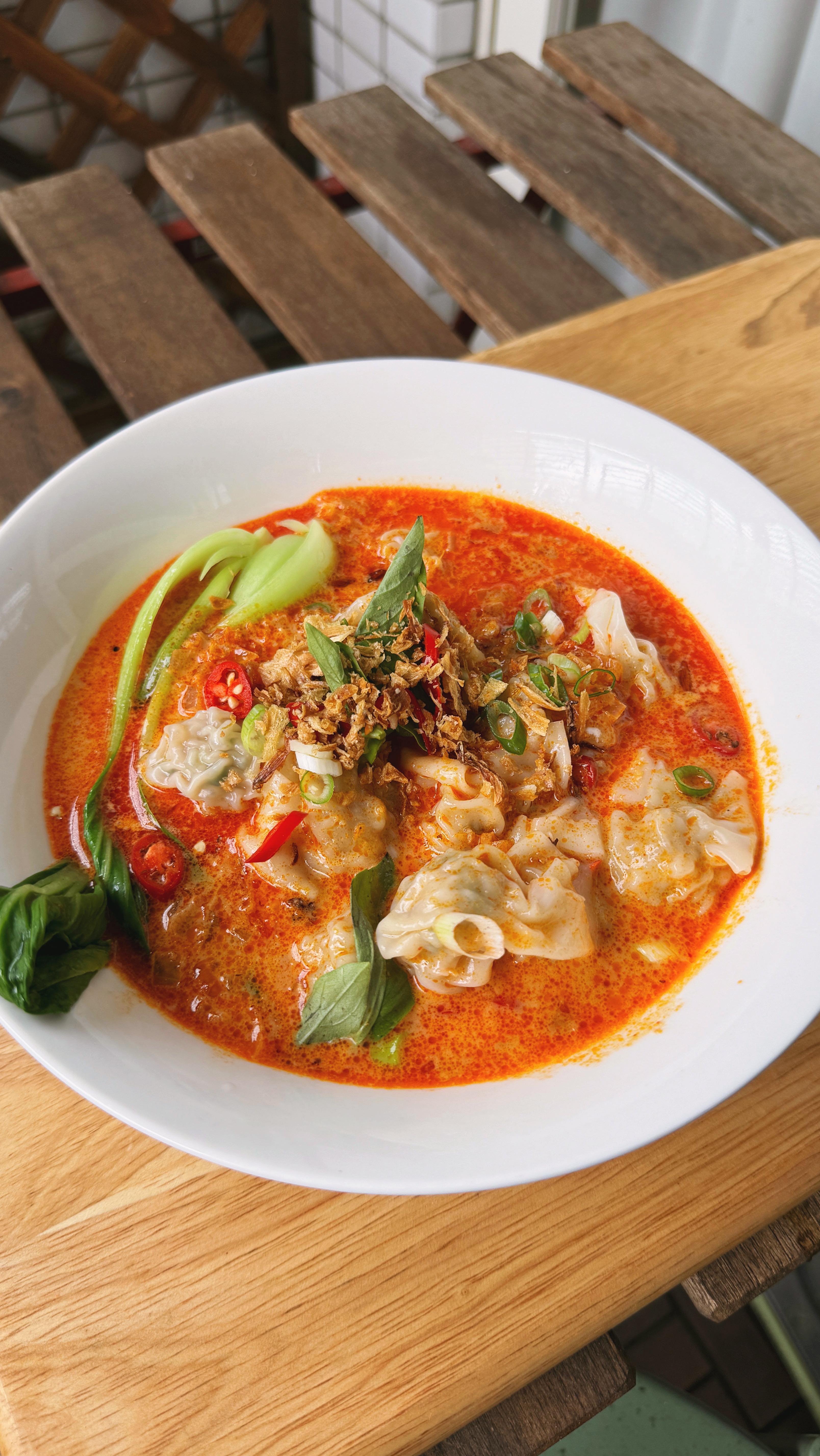 Vegetarian red curry wonton soup with Asian greens