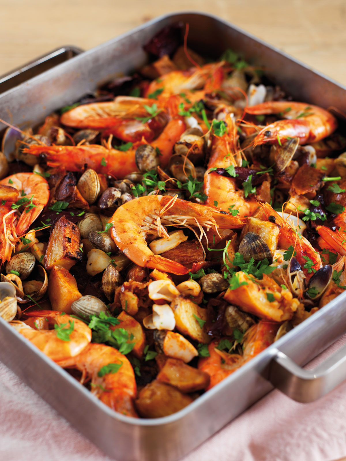 Roast seafood with potatoes, garlic, onion and lemon