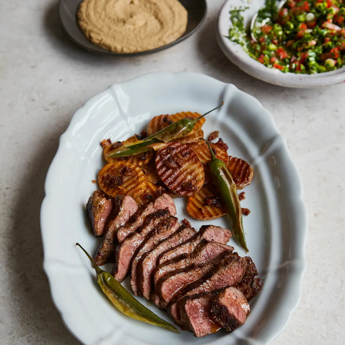 Mexican-style steak with crispy potatoes, salsa and peanut sauce