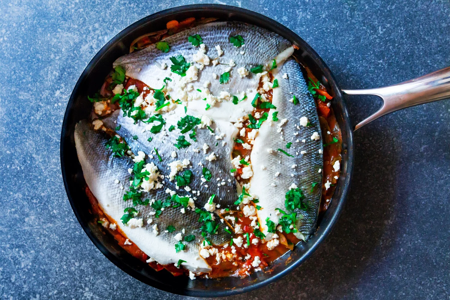 Moroccan spiced fish fillets with bell peppers in tomato sauce
