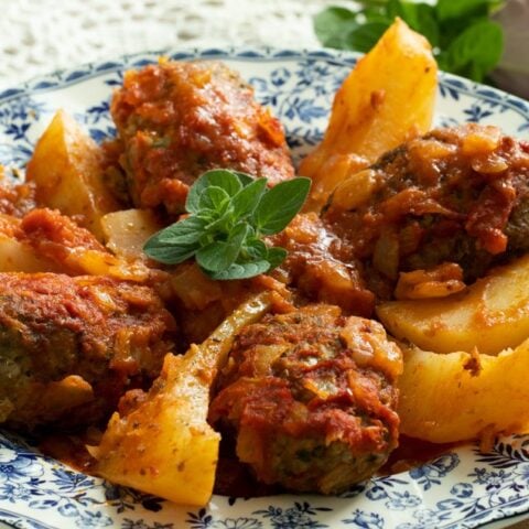 Beeftekia with roasted potatoes in tomato sauce