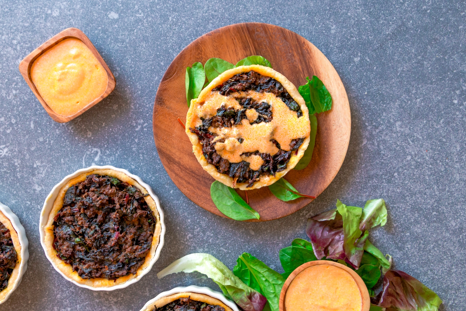 Kefta and Swiss chard quiche with goat cheese and harissa sauce